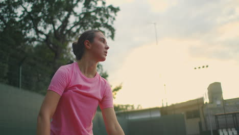 The-girl-on-the-central-service-line-repeatedly-knocks-the-ball-on-the-court-catches-the-ball-with-her-hand-and-serves.-Medium-shot.